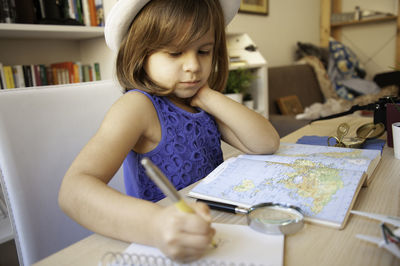 Girl sitting on table at home