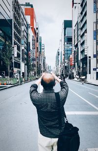 Rear view of woman standing in city