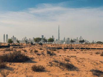 View of city buildings against cloudy sky