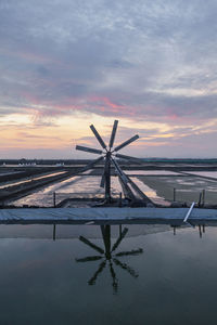 Scenic view of salt field against sky during sunrise