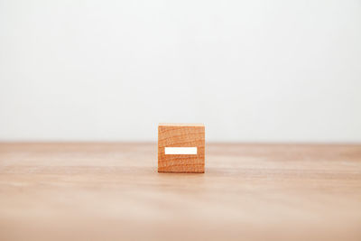 Close-up of wooden box on table against white background
