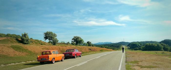 Retro car on empty road in countryside