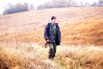 Full length of a man walking in field