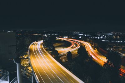 High angle view of light trails on road at night