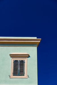 Low angle view of house against blue sky