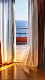 Scenic view of sea against sky seen through window