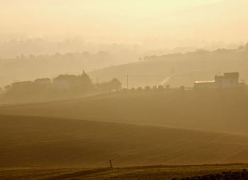 Scenic view of landscape against sky at sunset