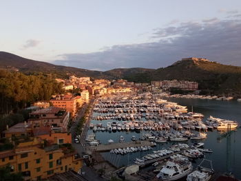 High angle view of townscape by sea against sky