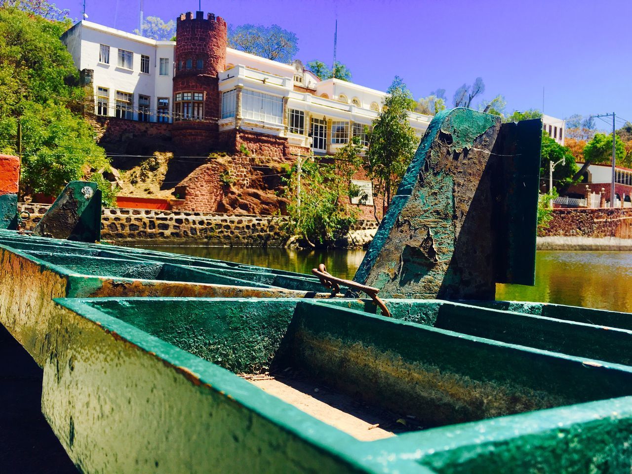 building exterior, architecture, fountain, built structure, water, outdoors, swimming pool, day, tree, no people, sky, close-up, water slide, water park