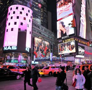 People on city street at night