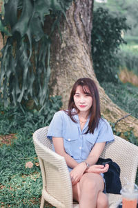 Portrait of a young woman sitting outdoors