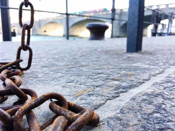 Close-up of chain on bridge over river