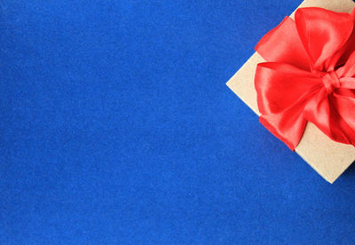 High angle view of red paper against blue background