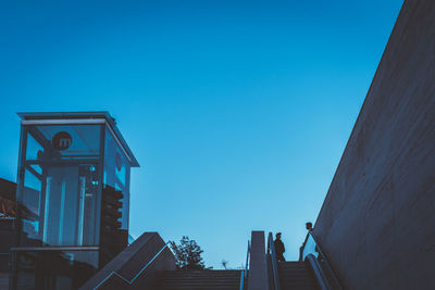 Low angle view of buildings against clear blue sky