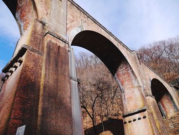 Low angle view of arch bridge against sky