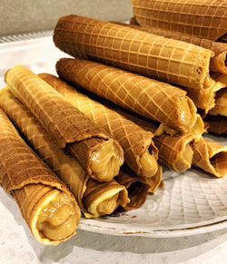 Appetizing wafer rolls with boiled condensed milk. delicious homemade sweets.