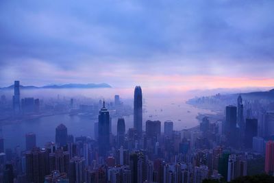 Aerial view of hong kong cityscape against sky during sunset