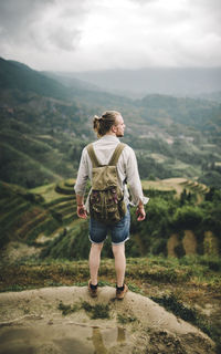 Rear view of man looking at mountains