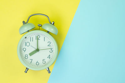 Low angle view of clock on wall