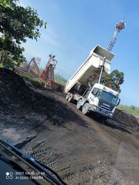 Construction site by road against sky