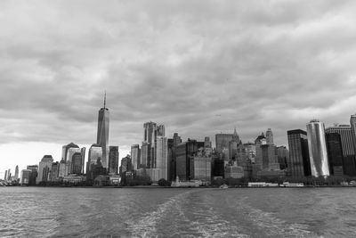 Modern buildings in city against cloudy sky