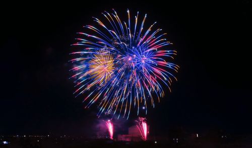 Low angle view of firework display at night