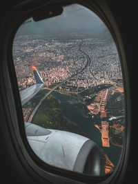 Aerial view of city seen through airplane window