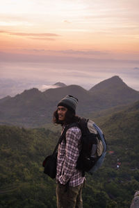 Man with backpack trekking in mountains. cumbiri hill, indonesia
