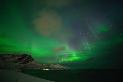 Aerial view of illuminated mountain against sky at night