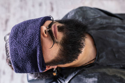 Close-up portrait of young man in snow
