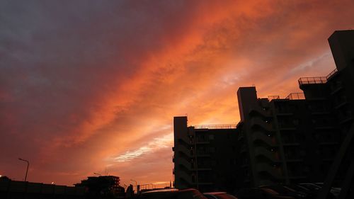Low angle view of buildings against sky during sunset