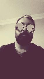 Close-up portrait of man against white background