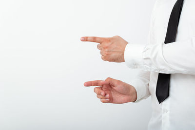 Midsection of man gesturing against white background