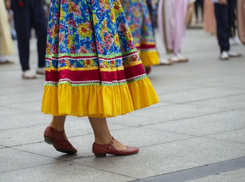 Low section of woman standing on street