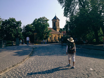 Woman standing on tree trunk