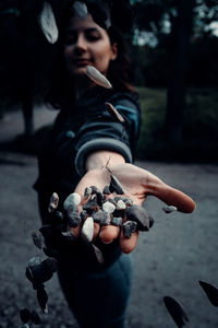 The girl is holding stones