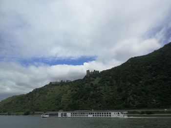 Scenic view of lake by mountains against sky