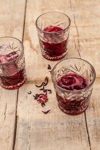 High angle view of red drink in glass on table