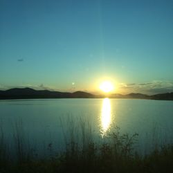 Scenic view of calm lake at sunset