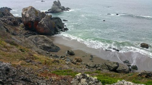 Resting and thinking overlook. red boulders on ocean shore aerial. background.