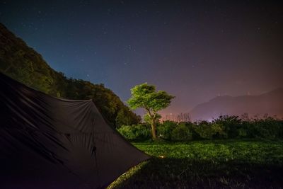 Tent on field against sky at night