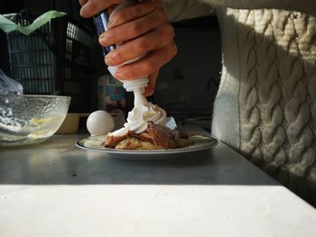 Midsection of person preparing food on table