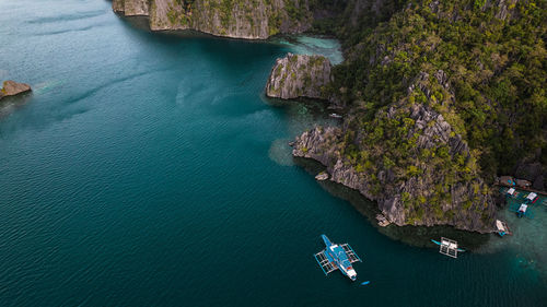 High angle view of boat and rocks in sea