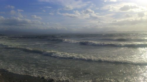 Scenic view of sea against cloudy sky