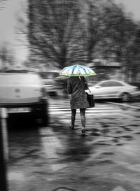 Blurred motion of man walking on road