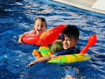 Portrait of boy swimming in pool