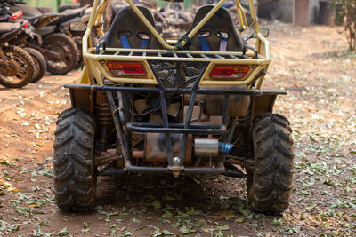 A yellow buggy is parked.