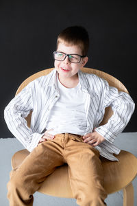 Portrait of young man sitting on sofa at home