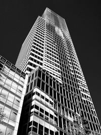 Low angle view of modern buildings against sky at night