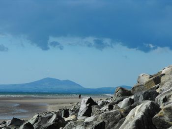 Scenic view of sea and mountains against sky